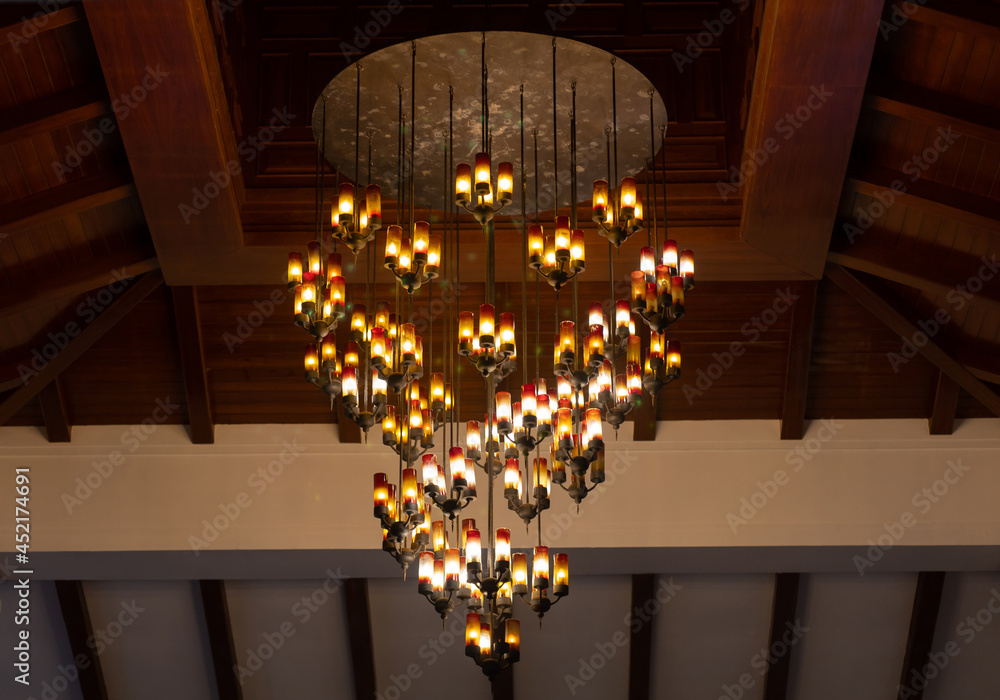 Chandeliers hanging ceiling yellow light at night.