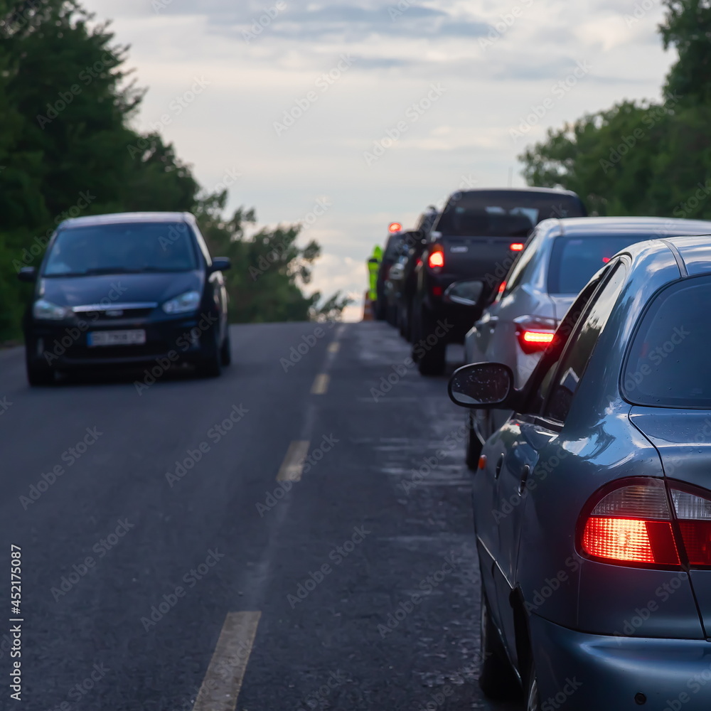 traffic jams on the road are associated with the repair of the roadway. evening