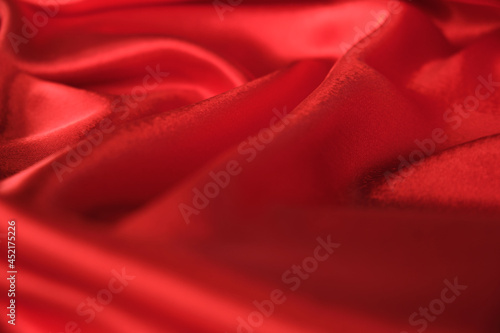 abstract texture of draped red velvet background. eautiful textile backdrop. Close-up. Top view