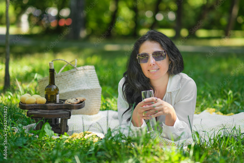 thoughtful woman sitting alone outdoors. elderly lady enjoying a summer day resting in the park. thoughtful woman sitting alone outdoors. elderly lady enjoying a summer day resting in the park.