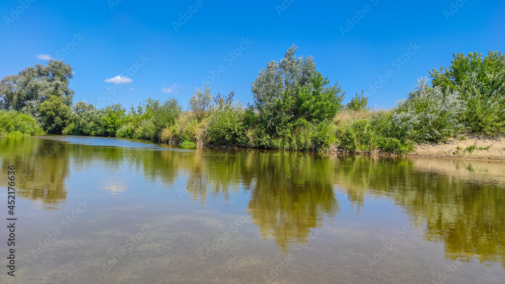 Landscape with a lake and clouds in the sky in the summer season