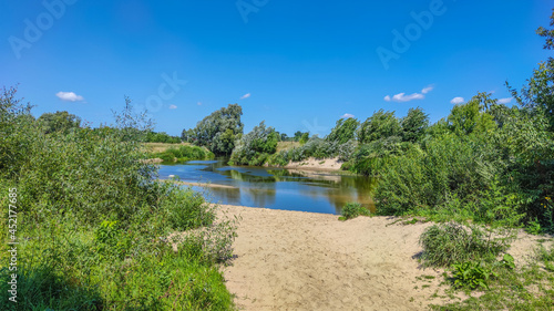 Landscape with a lake and clouds in the sky in the summer season