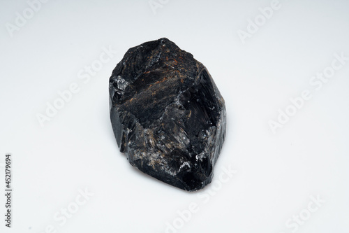 Natural black obsidian stone on white background