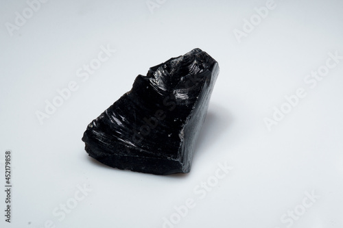 Natural black obsidian stone on white background