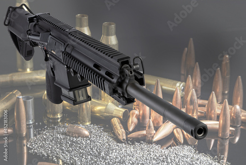 automatic army rifle with ammunition for shooting. black carbine and cartridges.