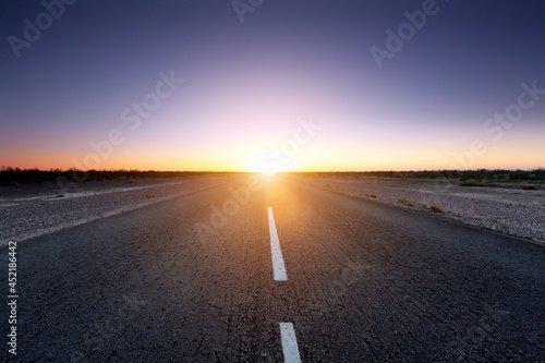 Beautiful sunset on the empty road. Travel freedom start concept idea