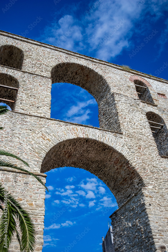 The old aqueduct of Kavala, Northern Greece. Partial view of this amazing bridge like construction under the blue sky.