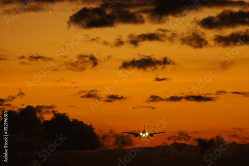sunset in the airport with a plane landing