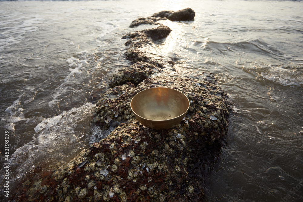 Vibration bowl in hands with sea background Vibration bowl in hands with sea background