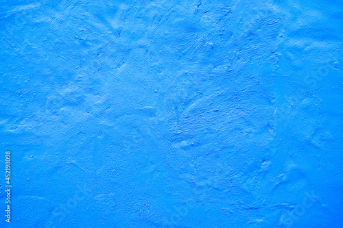 Vivid bright blue painted house wall, exterior or interior decoration, with texture and large empty text space.