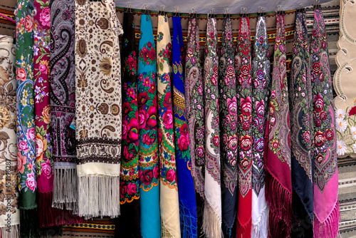 A set of colorful Ukrainian headscarves hanging at a street fair. National Ukrainian clothing. An important accessory for women.