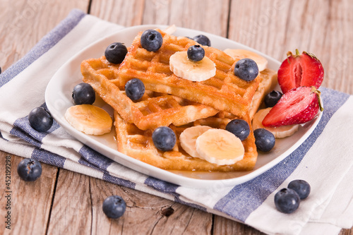Waffles with blueberries, bananas and honey.