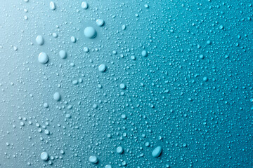 Water drops on smooth surface, blue background