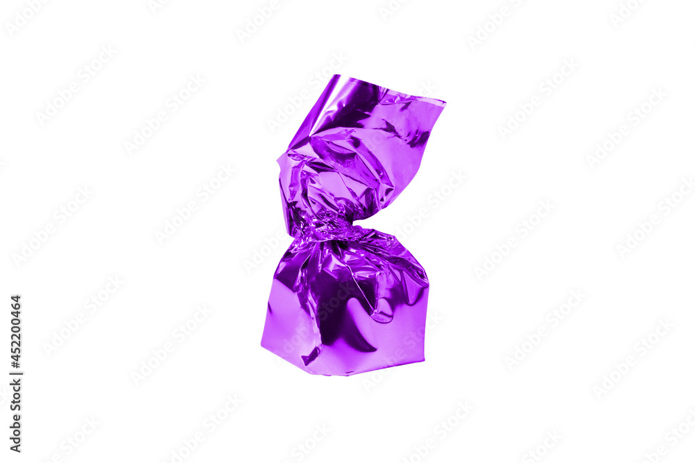 Chocolate candy in a purple wrapper isolated white background. Chocolate candy in a purple wrapper isolated white background.