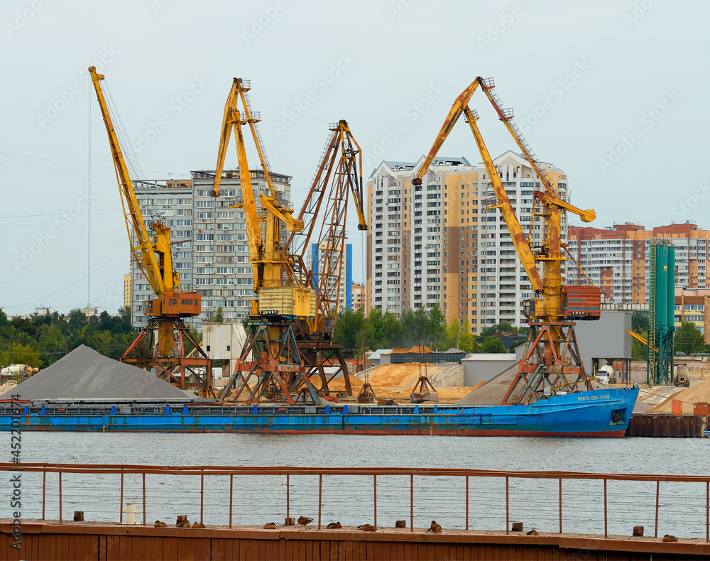 Naklejka premium Cargo loader at Moscow port delivery background