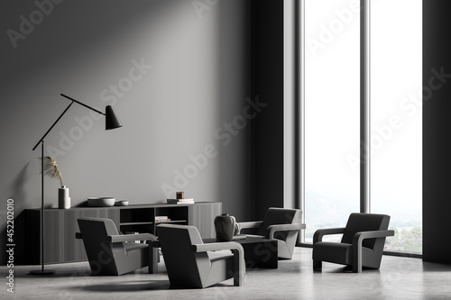 Dark grey panoramic seating area with four armchairs and lamp. Corner view.