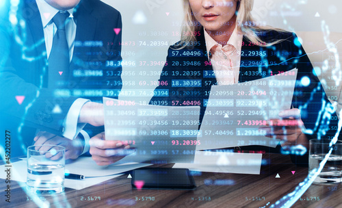 Fotografie Businessman and businesswoman in formal suit are holding papers