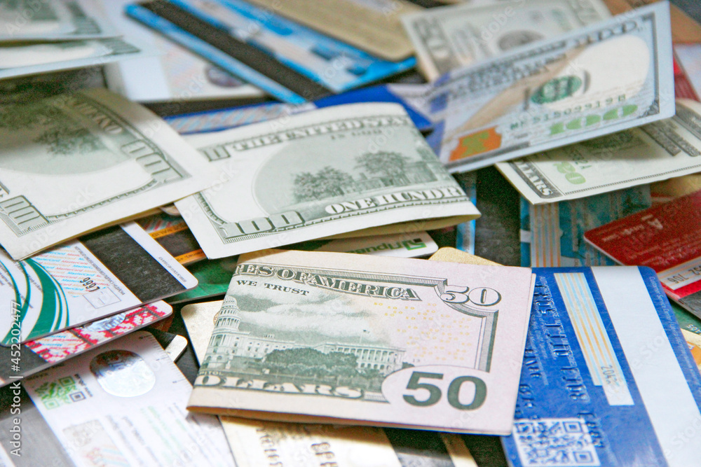 Hundred dollar notes and credit cards. Pile of credit cards in dollars Hundred dollar notes and credit cards. Pile of credit cards in dollars