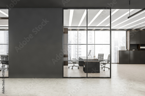 Black framed glass wall with grey detail near office entrance