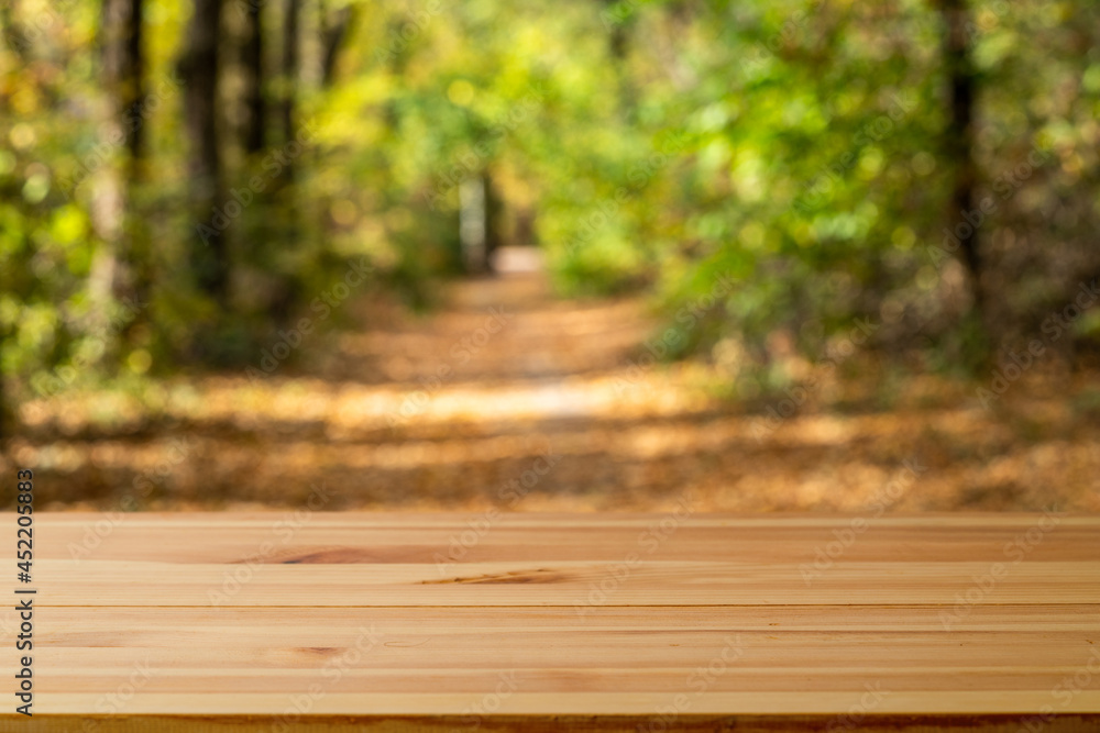 Wood table and blur green tree nature backdrop. Empty wooden table top, surface over blurred garden outdoor Wood table and blur green tree nature backdrop. Empty wooden table top, surface over blurred garden outdoor