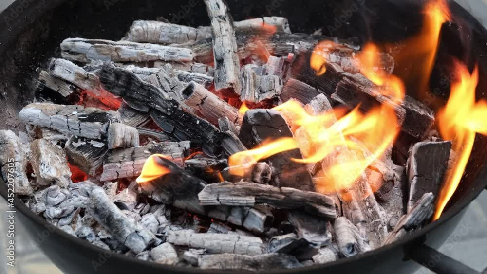 Burning charcoal in a barbeque grill. Burning charcoal in a barbeque grill.