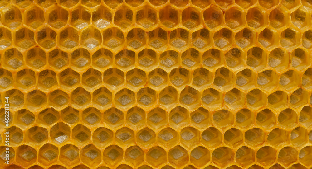 Hexagonal textured honeycomb background close-up. Black broun yellow background. Agricultural concept Hexagonal textured honeycomb background close-up. Black broun yellow background. Agricultural concept
