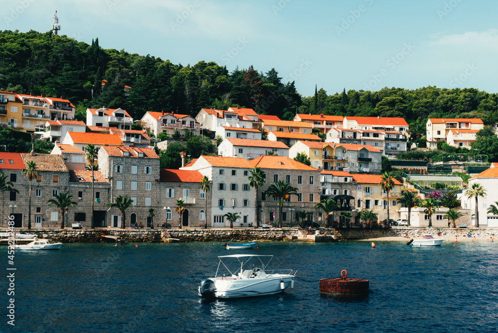 Moored boat on the background of beautiful Korcula resort town, Croatia