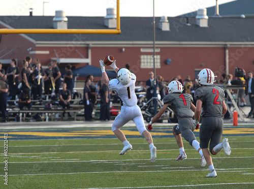 A pass is caught for a touchdown in a high school football game.