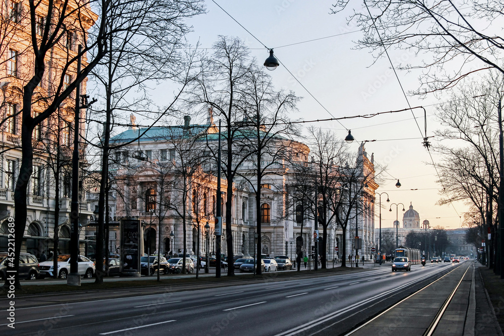 cityscape of empty street with old buildings at sunrise in Vienna  