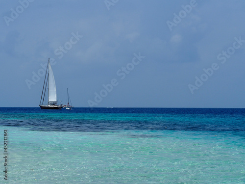 Sailing boat, clear water and beach in the Caribbean