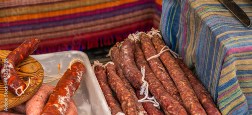 Typical Spanish sausages lying on a village stall at the food market