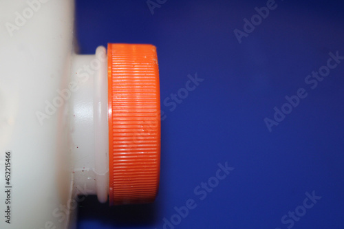 Plastic White Glue Bottle on Blue Background