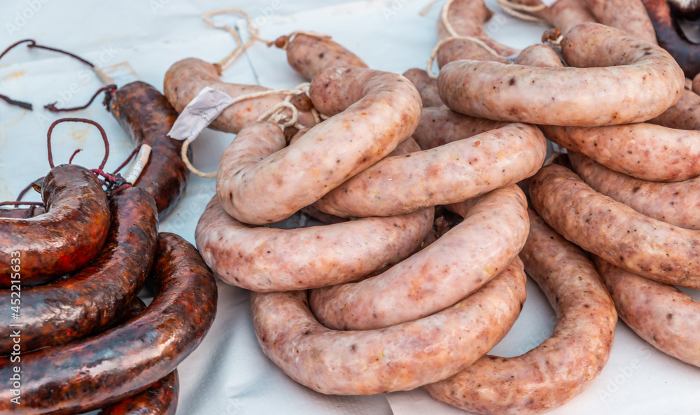 Typical Spanish sausages lying on a village stall at the food market Typical Spanish sausages lying on a village stall at the food market