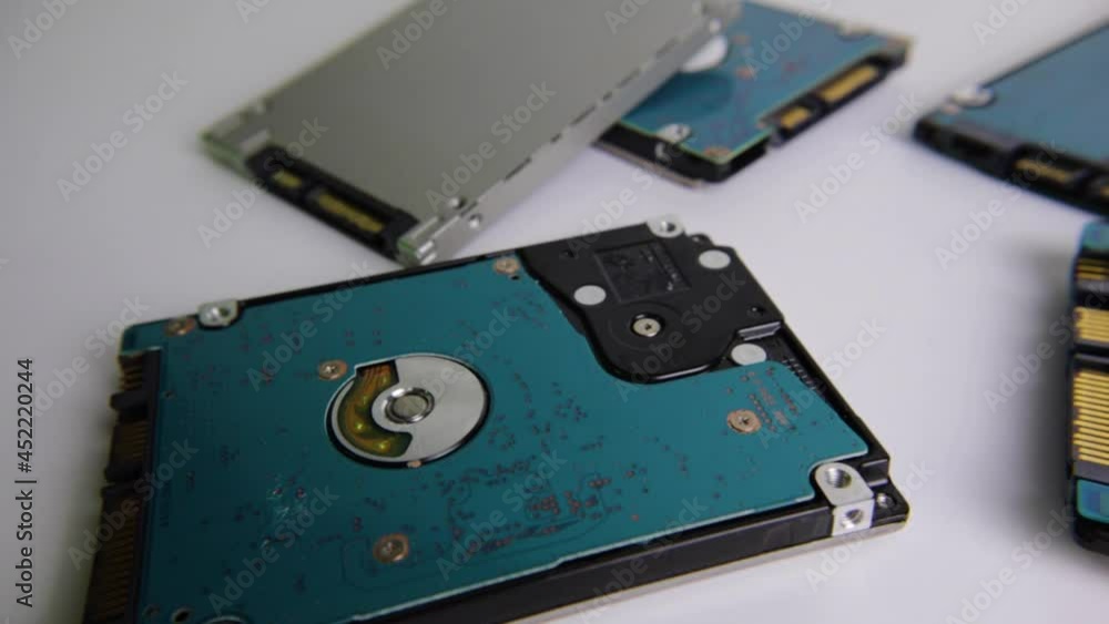 Right pan of scattered hard drives circuit board side and silver surface side selective focus Right pan of scattered hard drives circuit board side and silver surface side selective focus