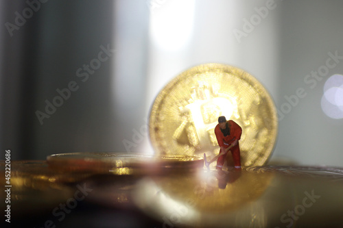 miniature people miner is digging on golden coin. Cryptocurrency bitcoin the future coin, Bitcoin blockchain crypto currency digital encryption, Digital money exchange, Technology global network photo