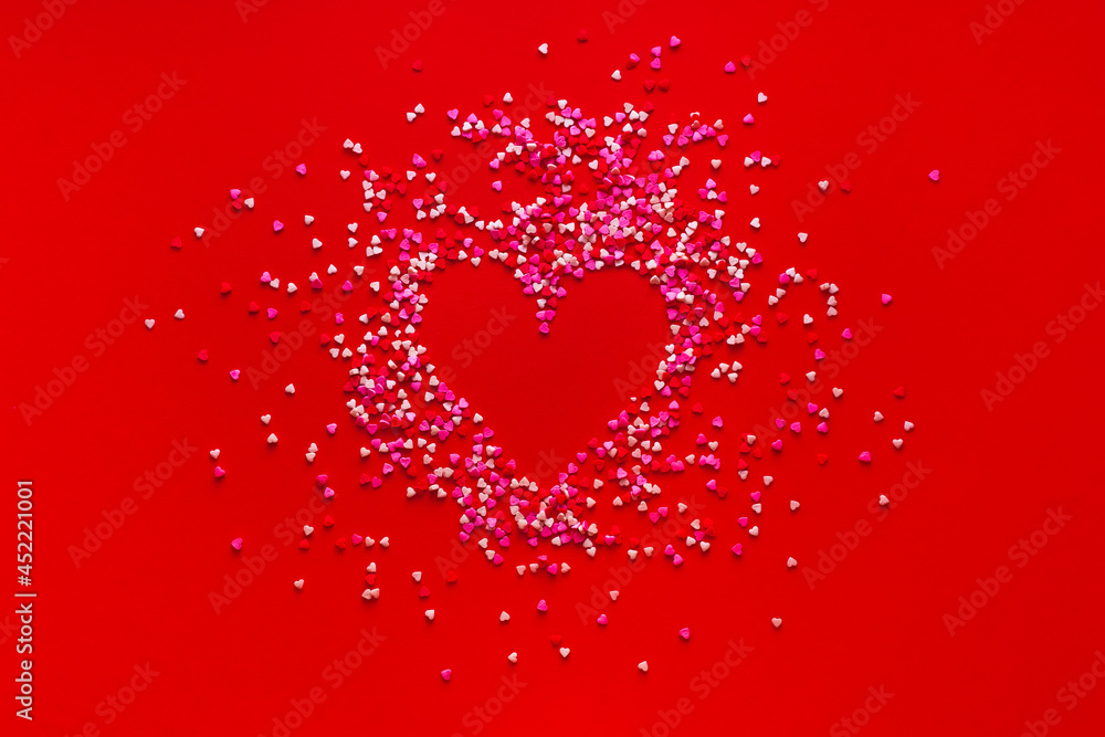Heart shape in culinary candy on red background. Valentine 8 March Mother Women's Day or sales and black friday concept. Creative romantic love pattern. Copy space, flat lay, top view Heart shape in culinary candy on red background. Valentine 8 March Mother Women's Day or sales and black friday concept. Creative romantic love pattern. Copy space, flat lay, top view