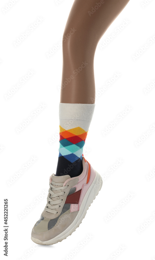 Woman wearing sneakers on white background, closeup