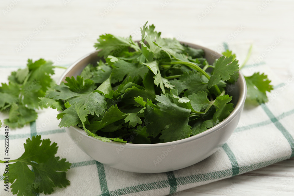 Fresh aromatic cilantro on white wooden table, closeup