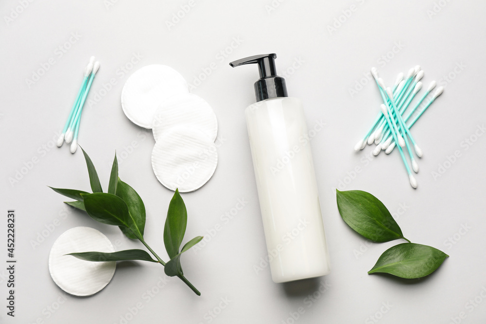 Cotton pads, swabs and makeup removal product on white background, flat lay Cotton pads, swabs and makeup removal product on white background, flat lay