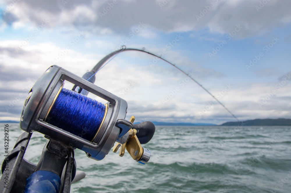 Rod and Reel on a boat Trolling (a form of fishing) for salmon in