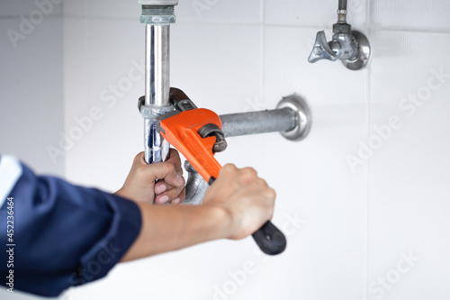 plumber at work in a bathroom, plumbing repair service, assemble and install concept.