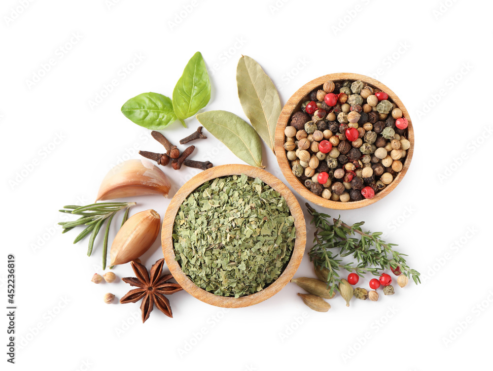 Different natural spices and herbs on white background, top view Different natural spices and herbs on white background, top view
