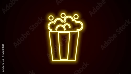 Glowing neon line Popcorn in cardboard box icon isolated on black background. Popcorn bucket box. 4K Video motion graphic animation