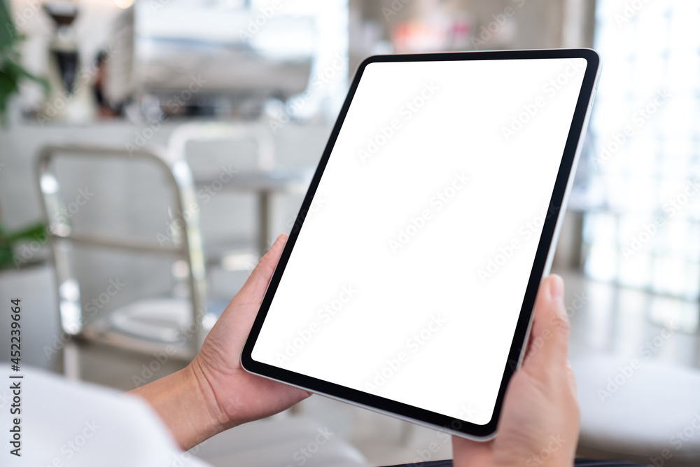 Mockup image of a woman holding digital tablet with blank white desktop screen Mockup image of a woman holding digital tablet with blank white desktop screen