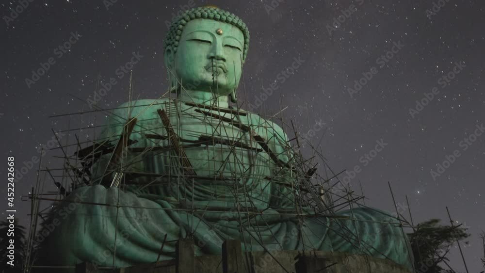 Time lapse 4K, Daibutsu or 'Giant Buddha' is a Japanese term often used informally for a large statue of Buddha, Giant Buddha with milky way moving in sky at night, Mae Tha Lampang Thailand. Time lapse 4K, Daibutsu or 'Giant Buddha' is a Japanese term often used informally for a large statue of Buddha, Giant Buddha with milky way moving in sky at night, Mae Tha Lampang Thailand.