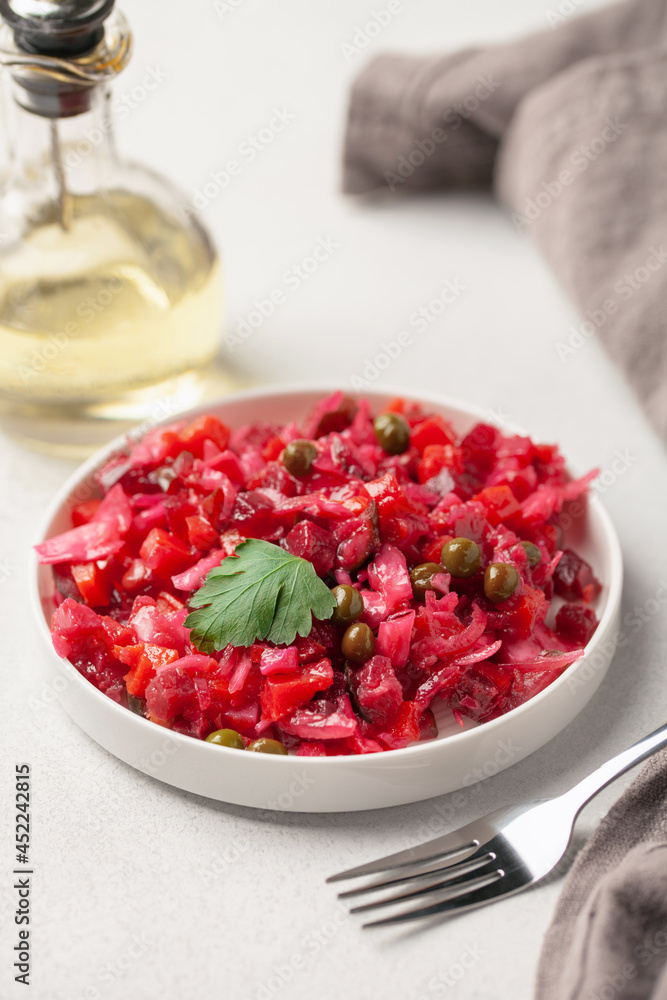 Salad vinaigrette with beets and vegetables on a plate on the table. Healthy diet Salad vinaigrette with beets and vegetables on a plate on the table. Healthy diet