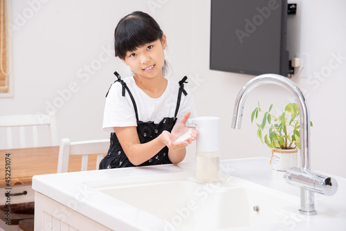 手を洗う小学生の女の子