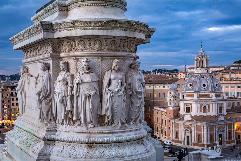 The huge marble sculptured stone base of Victor Emmanuel II statue, as seen from the Altar of the Fatherland, with background of Santa Maria di Loreto church in piazza di Venezia in Rome, Italy
