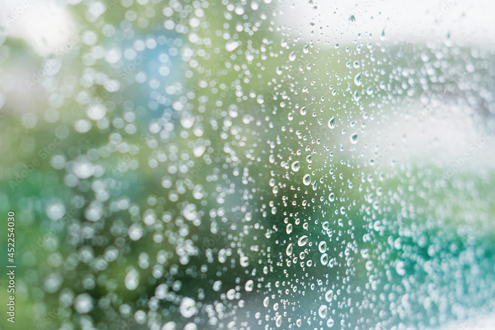 Rain drops on the surface of window with country background. autumn weather and meteorology concept