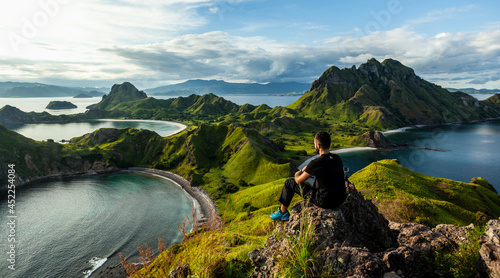 A man sitting on the rock on top of Padar island photo